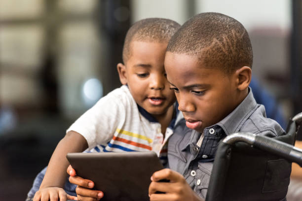 eleven years old african american boy playing with his 3 years old brother